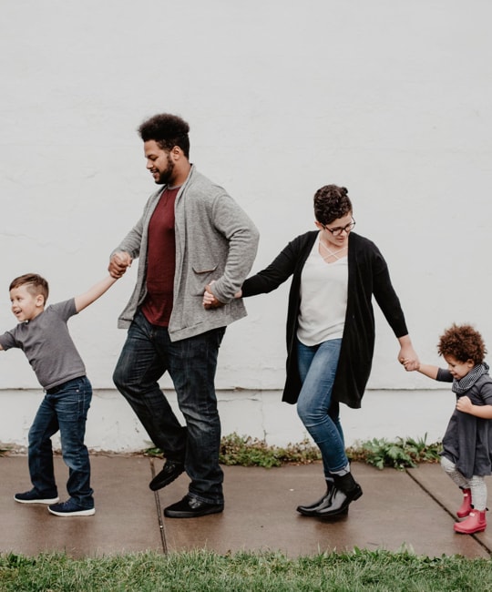 Happy Family of 4 Holding Each Other's Hands